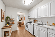 Arlington apartment for rent - A kitchen with white cabinets and a wooden island.