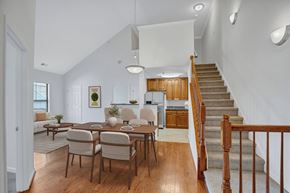 Lorton apartment for rent - A dining room with a wooden table and chairs.