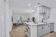 Arlington apartment for rent - A modern kitchen with white cabinets and a large island.