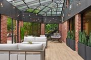 Woodbridge apartment for rent - A patio with a white couch and a glass roof.