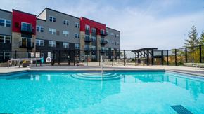 Lakeville apartment for rent - A swimming pool in front of a multi-story apartment building.