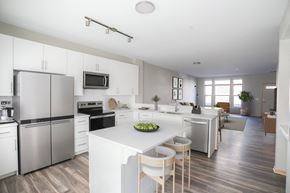 St. Louis Park townhouse for rent - a white kitchen with stainless steel appliances and a white counter top