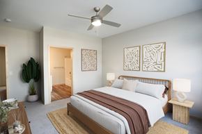 St. Louis Park townhouse for rent - a bedroom with a large bed and a ceiling fan