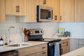 Plymouth apartment for rent - a kitchen with a sink and a stove and a microwave