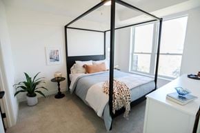 Plymouth apartment for rent - a bedroom with a four poster bed and a large window