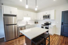 Duluth apartment for rent - a kitchen with stainless steel appliances and a white counter top