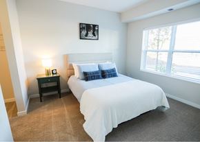 Duluth apartment for rent - A bedroom with a large bed and a window.