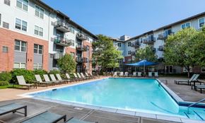 St. Louis Park townhouse for rent - A swimming pool surrounded by lounge chairs and apartment buildings.