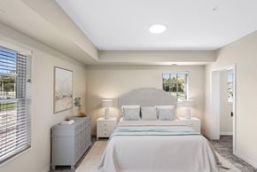 Victoria apartment for rent - a white bedroom with a large bed and a window