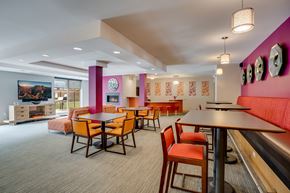 St. Louis Park apartment for rent - a dining area with tables and chairs and a pink divider