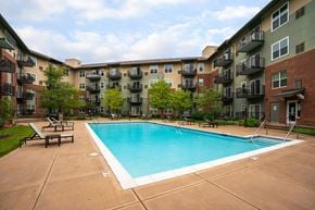 St. Louis Park apartment for rent - a swimming pool in front of an apartment building
