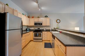 St. Louis Park apartment for rent - a kitchen with wooden cabinets and granite counter tops and stainless steel appliances