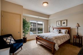 St. Louis Park apartment for rent - a bedroom with a bed and a chair and a window