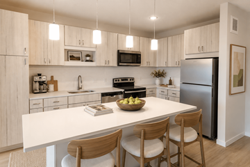 Brooklyn Park apartment for rent - A modern kitchen with a white table and wooden chairs.