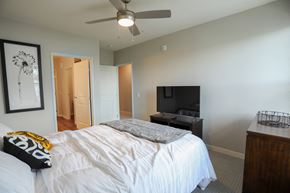 Tonka Bay townhouse for rent - a bedroom with a large bed and a ceiling fan