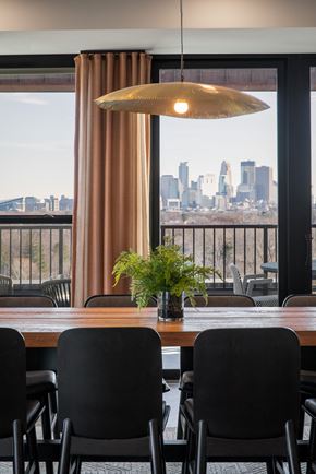 Minneapolis apartment for rent - a dining room with a table and chairs and a view of the city