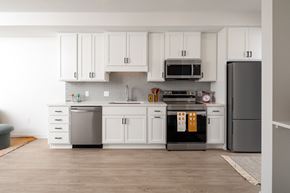 Minneapolis apartment for rent - a white kitchen with stainless steel appliances and white cabinets