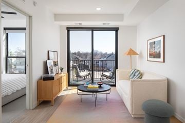 Minneapolis apartment for rent - a living room with a couch and a table and a balcony