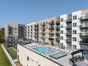 Plymouth apartment for rent - A large apartment complex with a pool and a patio area.