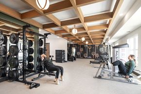Minnetrista apartment for rent - two women exercising in a gym with weights and machines