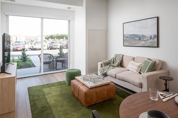 Minnetrista apartment for rent - a living room with a couch and a table in front of a window