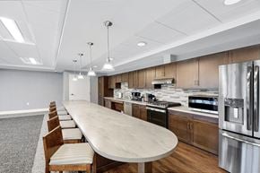 Victoria apartment for rent - a kitchen with stainless steel appliances and a marble counter top