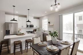 Mound townhouse for rent - A modern kitchen with a dining table set for two.