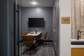 Minnetonka apartment for rent - A conference room with a table, chairs, and a sign on the wall.