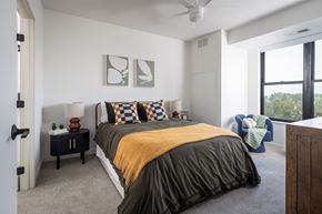 Minnetonka apartment for rent - A bedroom with a bed, a nightstand, and a ceiling fan.
