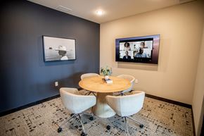 Plymouth apartment for rent - a dining room with a table and chairs and a television on the wall