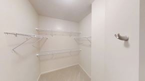 Auburn Hills apartment for rent - a spacious walk in closet with white walls and shelves