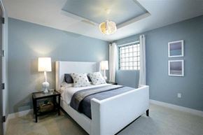 Grand Rapids apartment for rent - A bedroom with a bed, nightstand, and lamp.