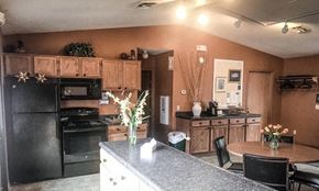 Ludington apartment for rent - a kitchen with black appliances and a table