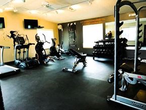 Ludington apartment for rent - a gym with a bunch of exercise equipment in it
