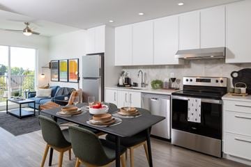 Vancouver apartment for rent - A modern kitchen with a dining table set for two.