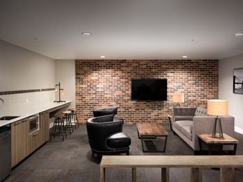 Comfortable and chic amenity lounge with kitchenette and large screen, cable tv for socializing and private parties