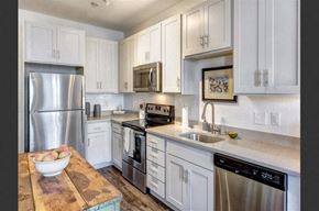 Mount Pleasant apartment for rent - a kitchen with stainless steel appliances and white cabinets