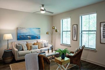 Mount Pleasant apartment for rent - A living room with a couch, a chair, a table, and a painting on the wall.