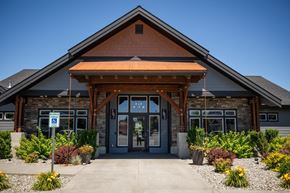 Spokane Valley townhouse for rent - the front entrance of a brick building with a porch and a sidewalk at The Brix Apartments, Spokane Valley, WA, 99037