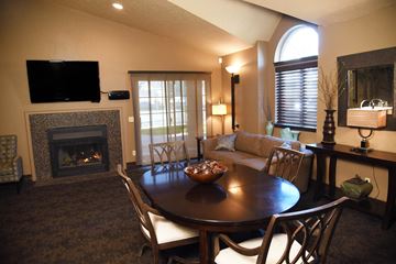 Spokane apartment for rent - a living room with a fireplace and a dining table