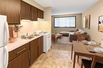 Spokane apartment for rent - A kitchen with brown cabinets and a white refrigerator.