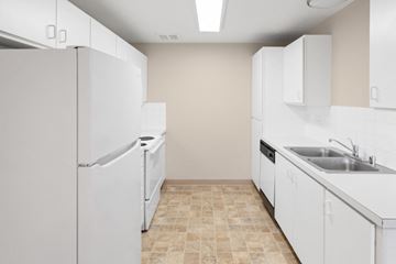 Spokane apartment for rent - A kitchen with white appliances and cabinets.