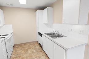 Spokane apartment for rent - A kitchen with white appliances and cabinets.