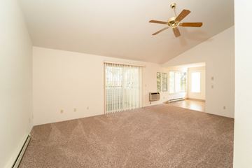 Spokane apartment for rent - a living room with carpet and a ceiling fan