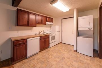 Spokane apartment for rent - a kitchen with white appliances and wooden cabinets