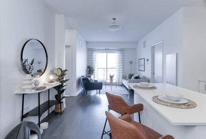 Edmonton apartment for rent - A modern dining room with a white table and brown chairs.