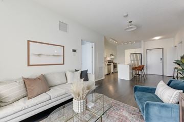 Edmonton apartment for rent - A living room with a white couch and a glass coffee table.