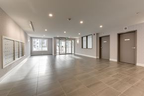 Edmonton apartment for rent - A spacious hallway with tiled floors and white walls.