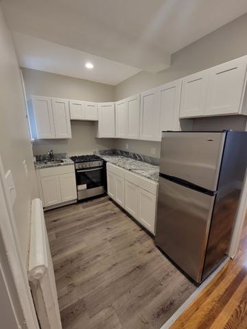 Albany apartment for rent - A kitchen with white cabinets and a stainless steel refrigerator.