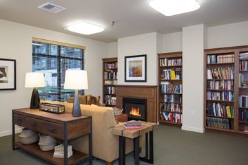 Covington apartment for rent - A living room with a fireplace, bookshelves, and a table with a lamp.